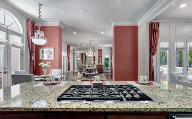 kitchen featuring an inviting chandelier, recessed lighting, crown molding, decorative light fixtures, and stainless steel gas stovetop