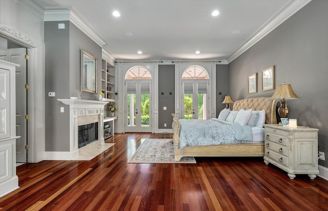 bedroom with access to outside, ornamental molding, recessed lighting, a fireplace, and hardwood / wood-style floors