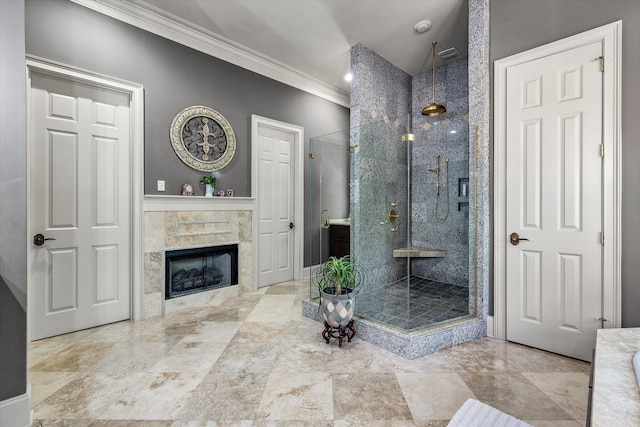 bathroom featuring a shower stall, a fireplace, baseboards, and ornamental molding