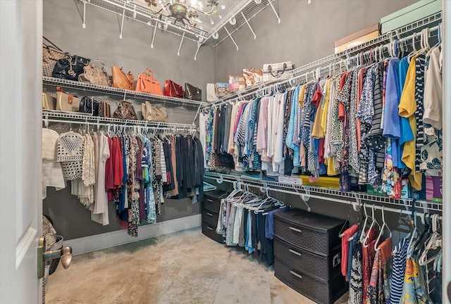walk in closet featuring an inviting chandelier