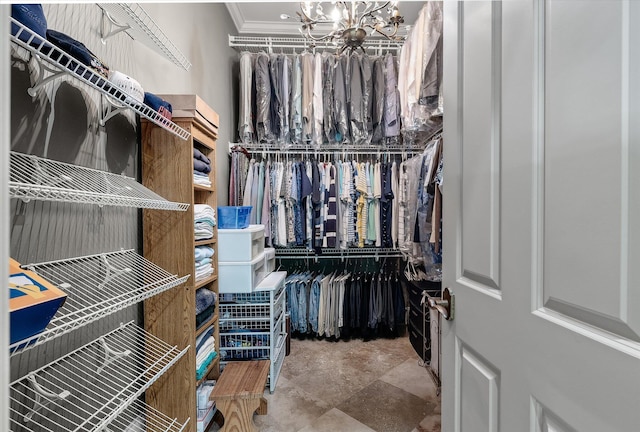 walk in closet featuring an inviting chandelier