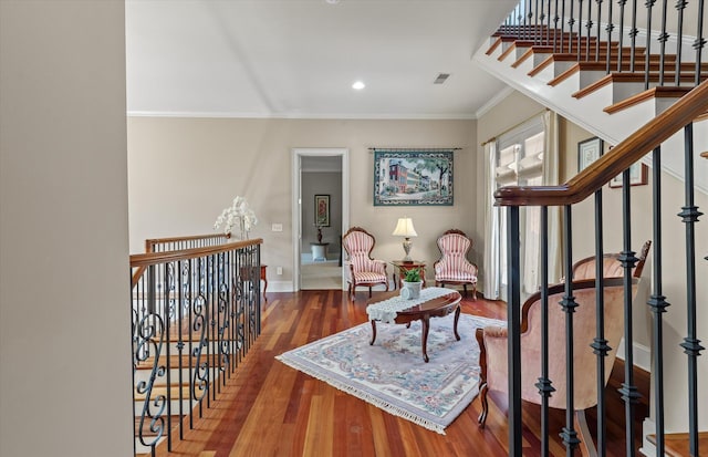 sitting room featuring ornamental molding, visible vents, recessed lighting, wood finished floors, and baseboards