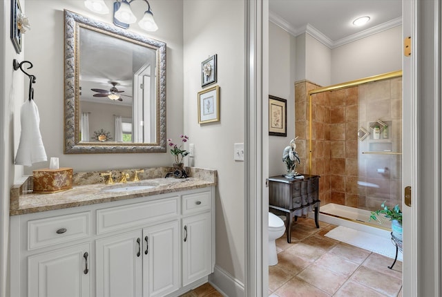 full bath featuring vanity, ornamental molding, a ceiling fan, toilet, and a shower stall