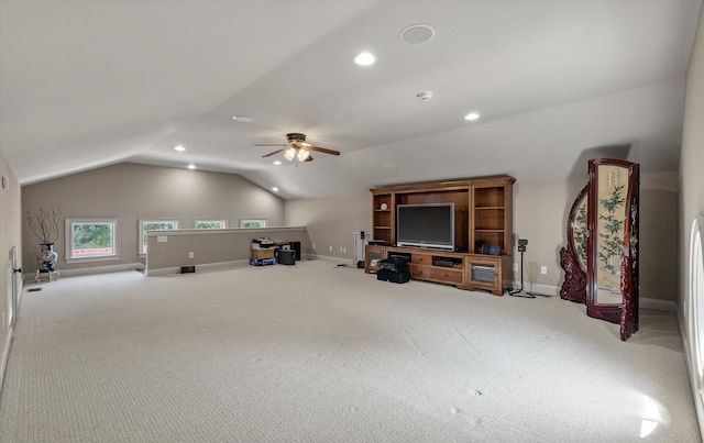 interior space with baseboards, a ceiling fan, recessed lighting, vaulted ceiling, and carpet flooring