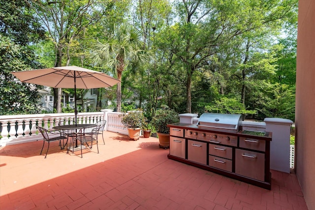 view of patio featuring area for grilling, outdoor dining space, and exterior kitchen