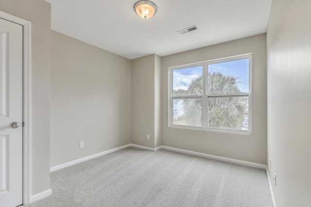 spare room with light colored carpet