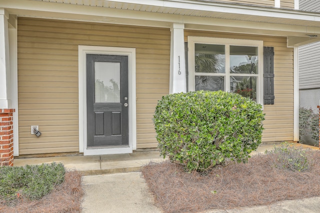 view of exterior entry with covered porch