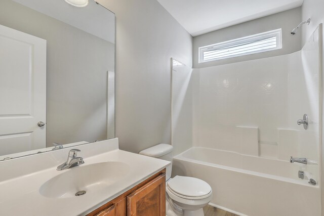 full bathroom with vanity, toilet, and washtub / shower combination