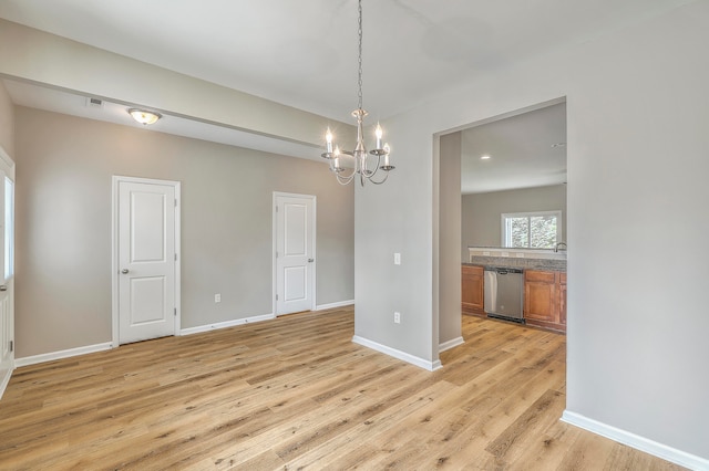 interior space featuring light hardwood / wood-style flooring, sink, and a notable chandelier