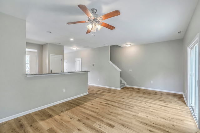 empty room with light wood-type flooring and ceiling fan