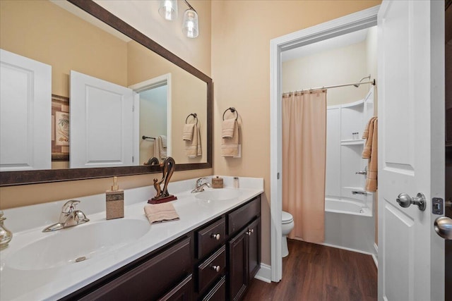 full bathroom with shower / tub combo, a sink, toilet, and wood finished floors