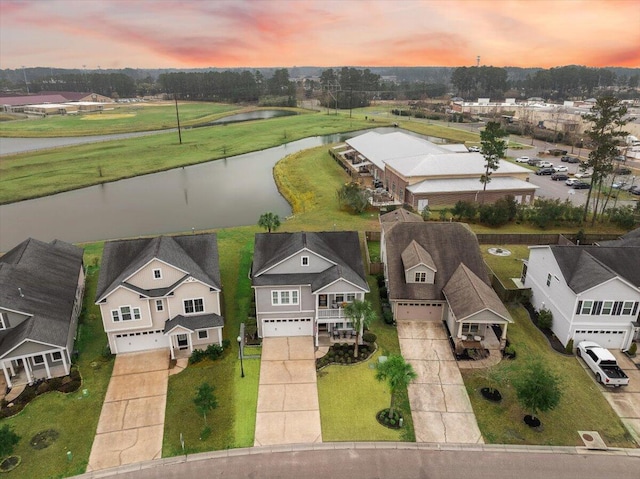 birds eye view of property with a residential view and a water view