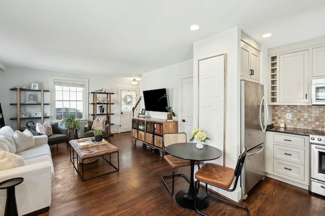 living area featuring dark wood finished floors and recessed lighting