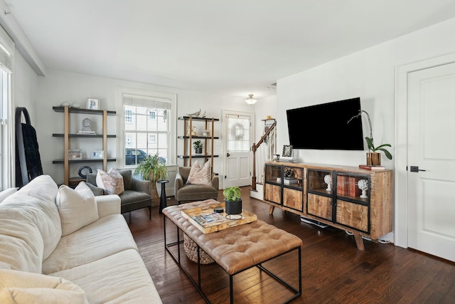 living room featuring wood finished floors and stairs