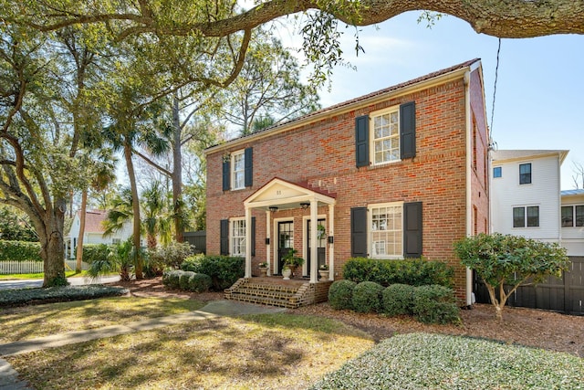 colonial-style house featuring brick siding