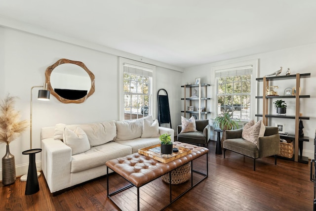 living room featuring baseboards, a healthy amount of sunlight, and dark wood-style floors