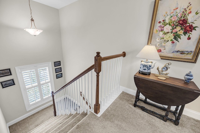 stairway featuring carpet floors and baseboards