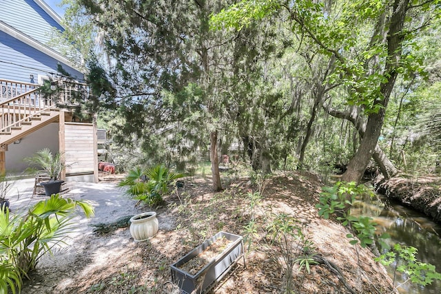 view of yard featuring stairs and a patio area