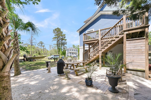 view of patio with stairs and a deck