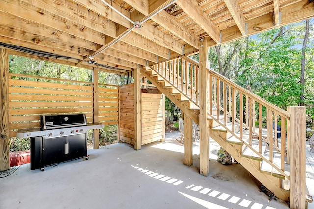 view of patio with grilling area and stairway