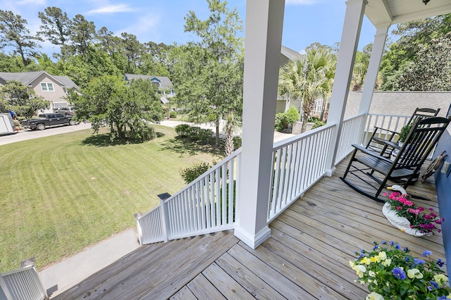 deck with a yard and covered porch