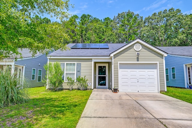 ranch-style house featuring a garage, a front lawn, and solar panels