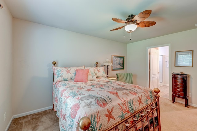 carpeted bedroom with ceiling fan and ensuite bath