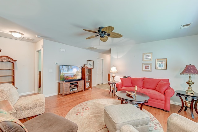 living room with ceiling fan and light hardwood / wood-style flooring