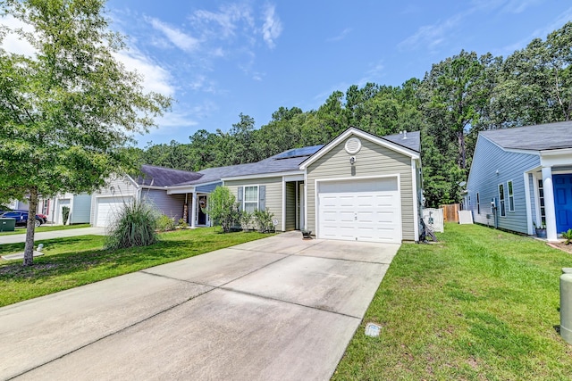 single story home featuring a garage, a front yard, and solar panels