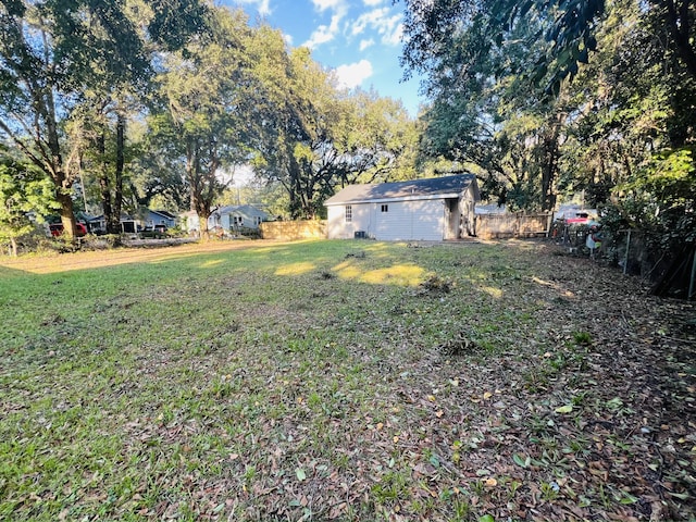 view of yard featuring an outbuilding and fence