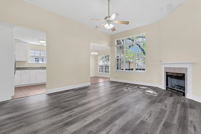 7869 High Maple Cir N, Charleston, SC 29418 - unfurnished living room featuring a fireplace, wood finished floors, ceiling fan, and baseboards