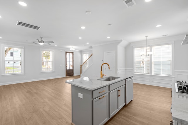 kitchen with gray cabinets, light hardwood / wood-style flooring, stainless steel dishwasher, and crown molding