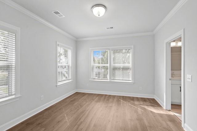 spare room with light hardwood / wood-style floors and ornamental molding