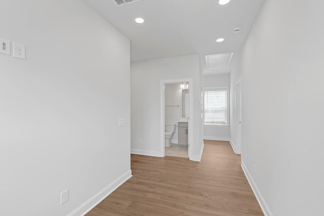 corridor with light wood-type flooring