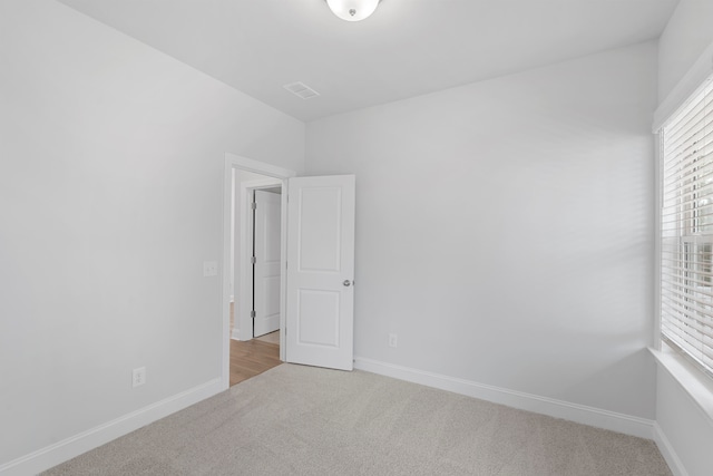 empty room featuring light carpet