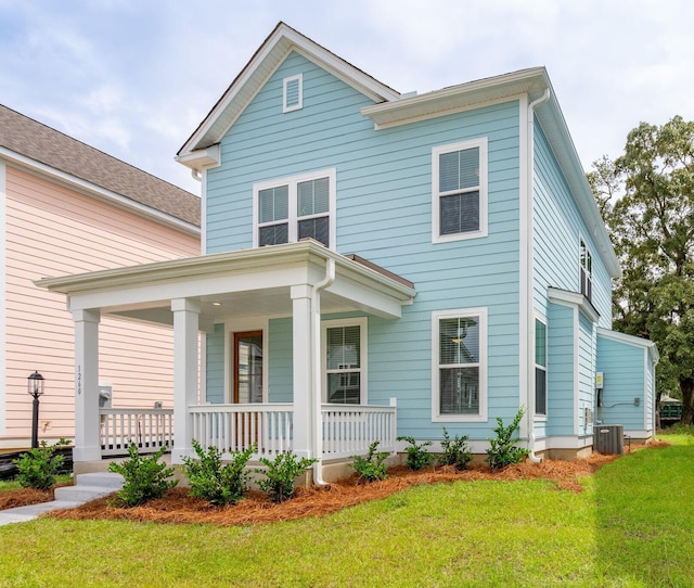 view of front of property featuring covered porch, central air condition unit, and a front lawn