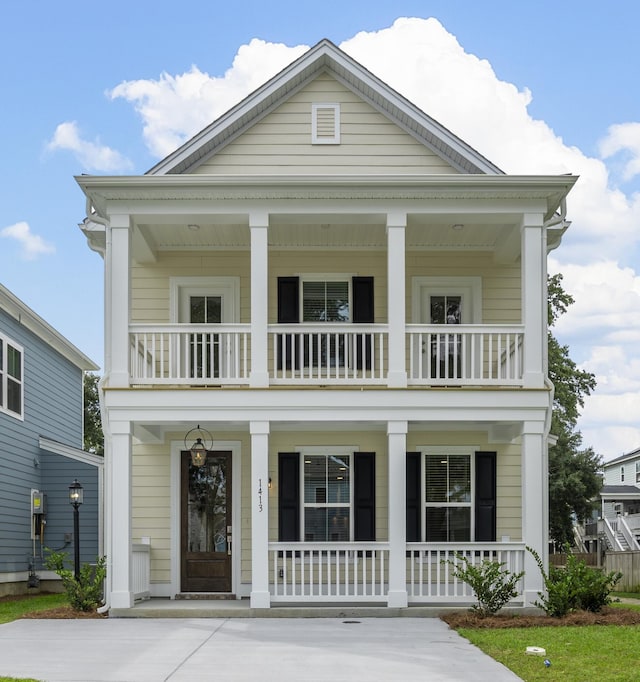 neoclassical / greek revival house featuring a balcony