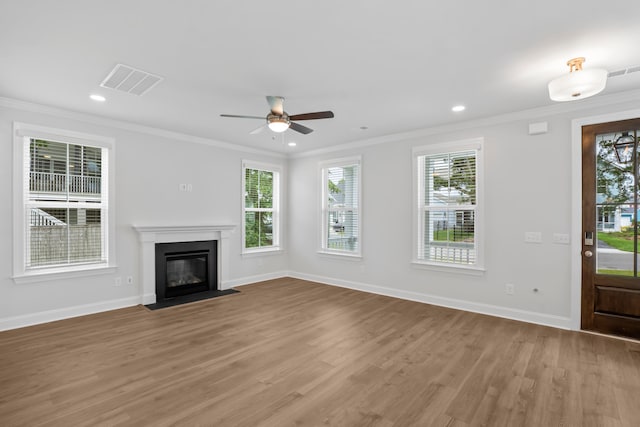 unfurnished living room featuring ceiling fan, light wood-type flooring, and crown molding