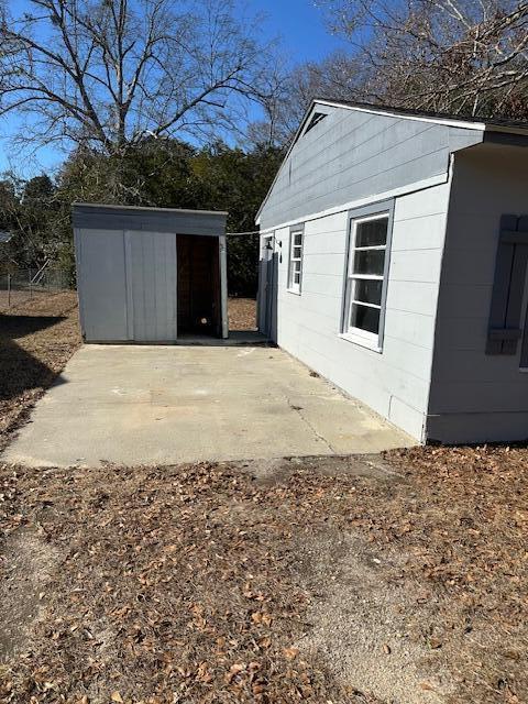 view of home's exterior featuring a patio and an outdoor structure