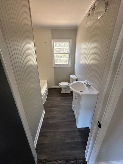 bathroom featuring toilet, wood-type flooring, and vanity