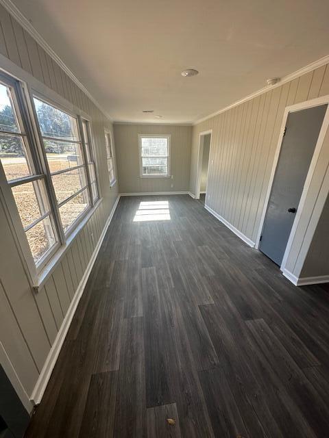 interior space with ornamental molding and dark hardwood / wood-style flooring