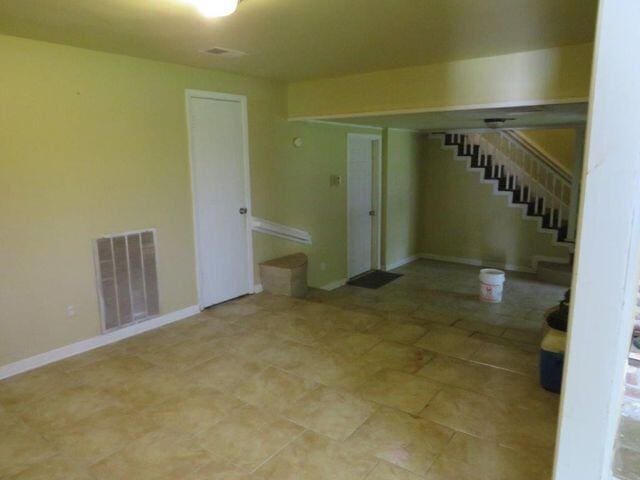 unfurnished room with light tile floors