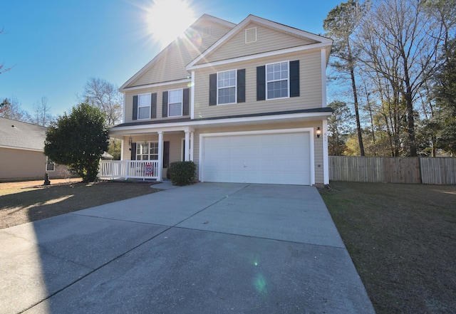 traditional-style house with driveway, an attached garage, fence, a porch, and a front yard