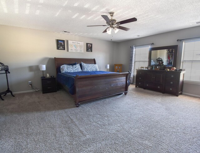 carpeted bedroom with a textured ceiling, ceiling fan, visible vents, and baseboards