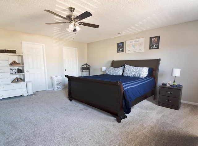 bedroom featuring ceiling fan, a textured ceiling, and carpet flooring