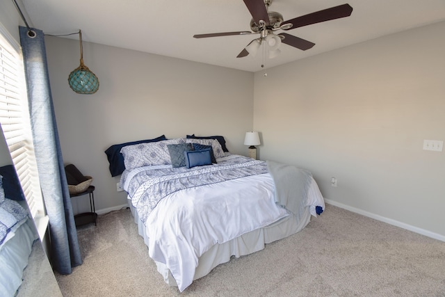 carpeted bedroom featuring ceiling fan and baseboards