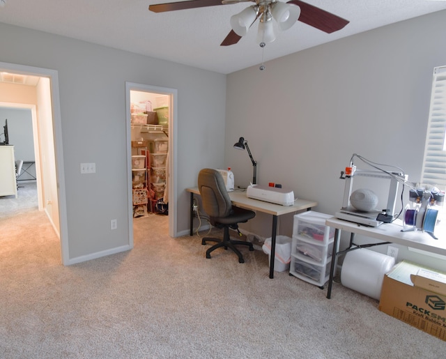 home office featuring carpet, visible vents, ceiling fan, and baseboards