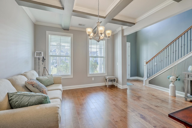 living room featuring light hardwood / wood-style floors, coffered ceiling, an inviting chandelier, ornamental molding, and beam ceiling