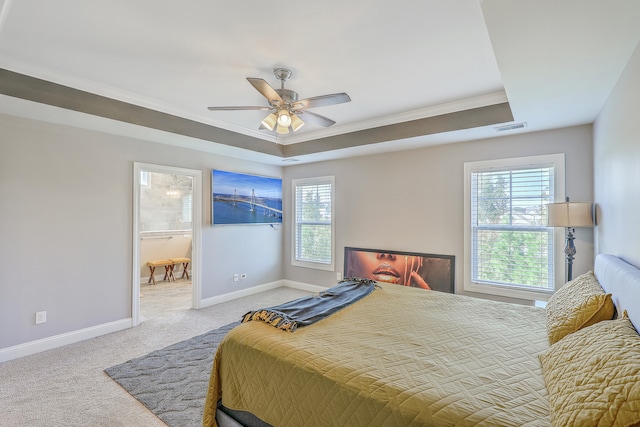 bedroom with ceiling fan, a raised ceiling, light carpet, and crown molding