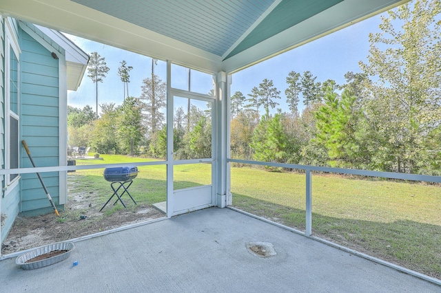 unfurnished sunroom featuring vaulted ceiling